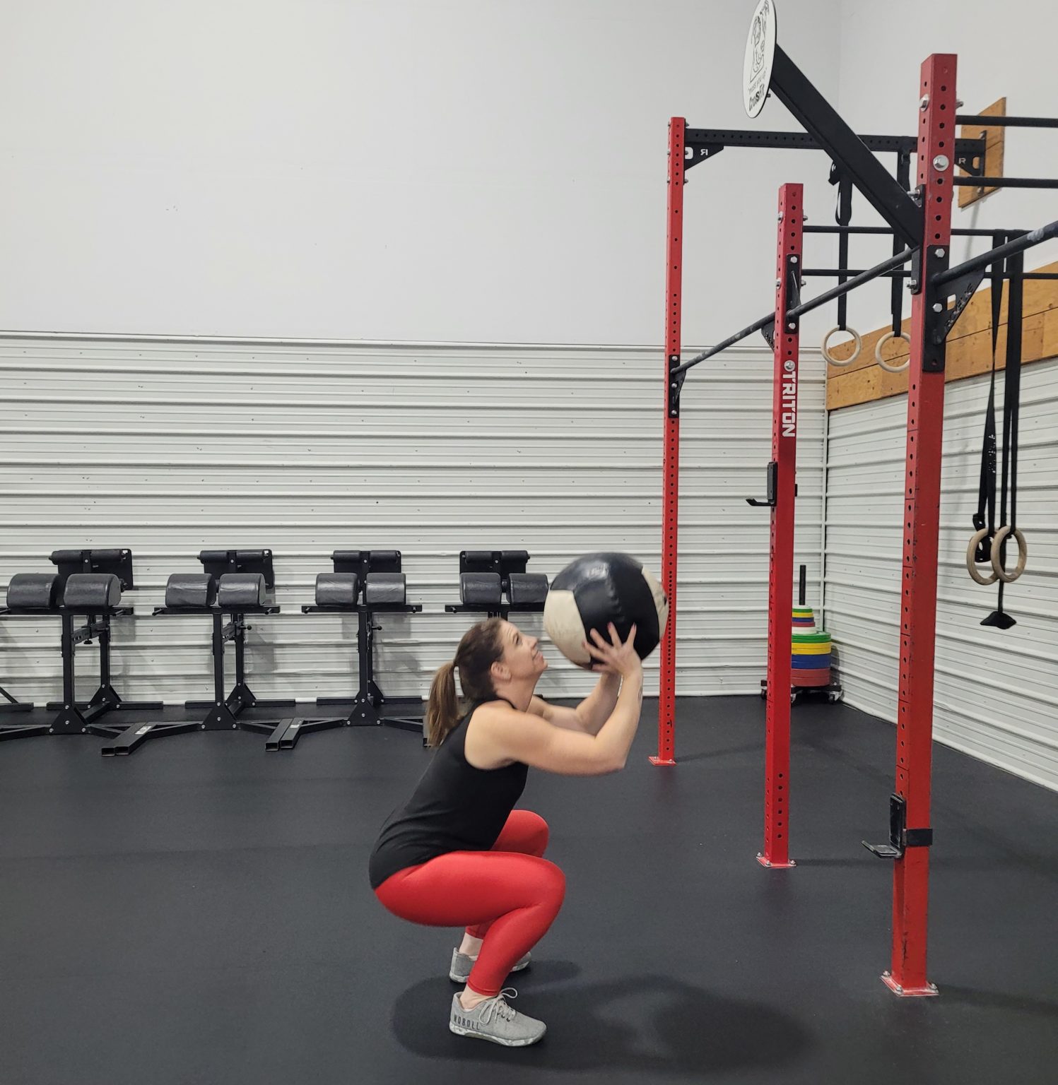 Woman in squat with medicine ball